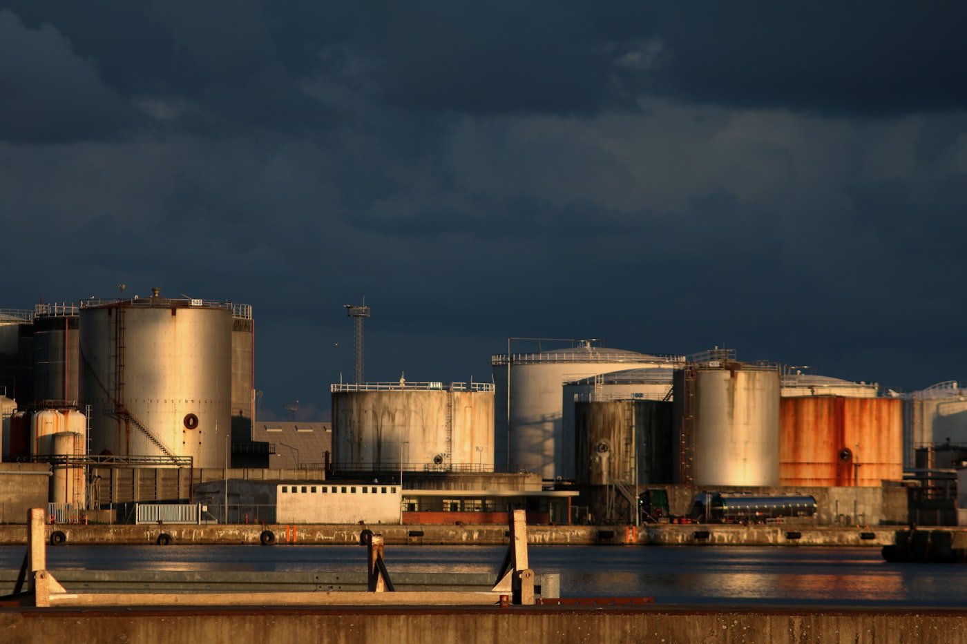 Oil storage tank farm and refinery terminal at golden hour