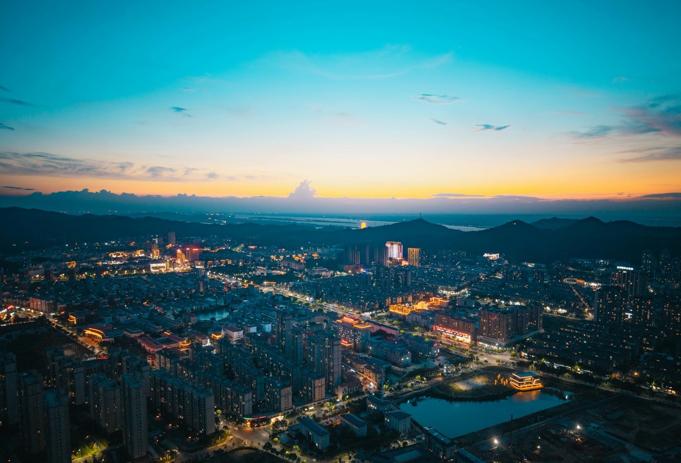 Expanding city skyline illuminated at dusk