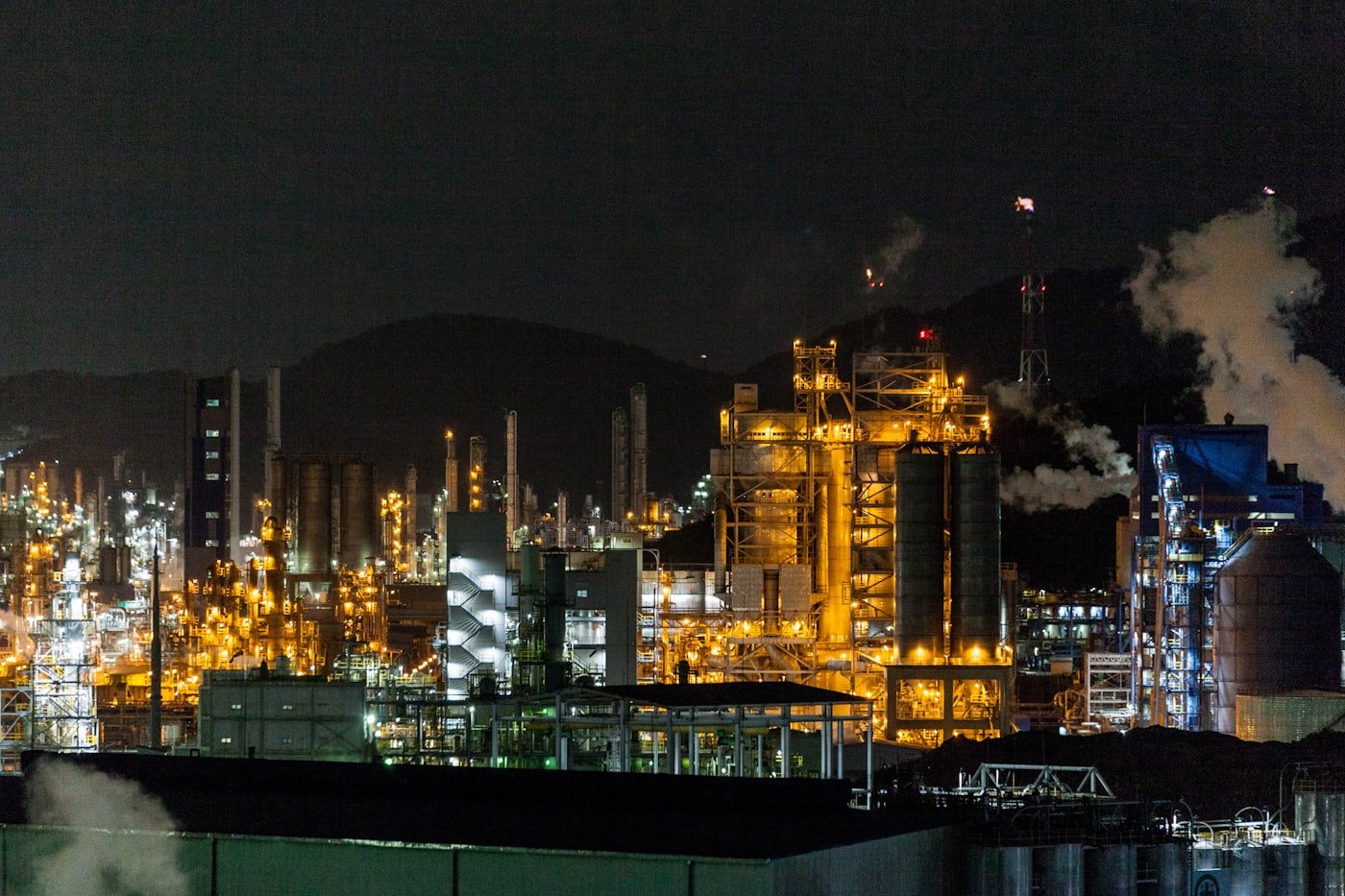 Large-scale industrial processing facility illuminated at night