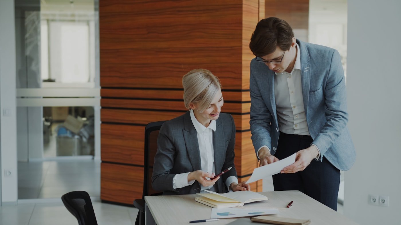 Finance professionals reviewing transaction documents in an office